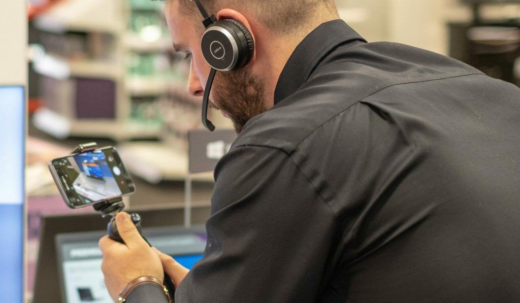 a salesman make video call with mobile phone and shows the products.
